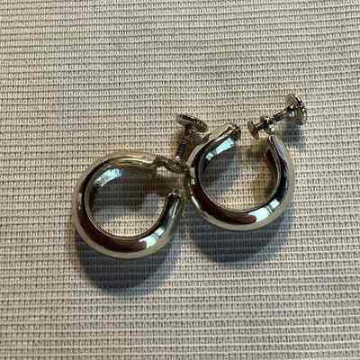 Pair of silver toned, hoop earrings with screw back.