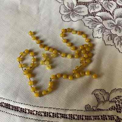 Broken, yellow beaded necklace