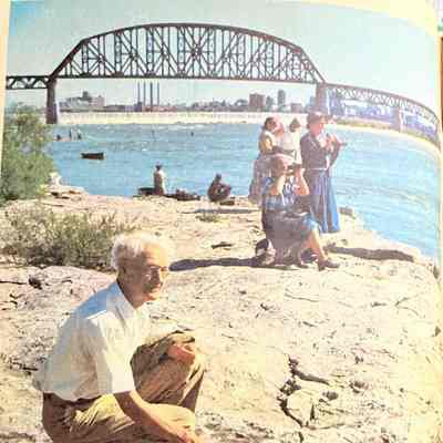 Inside front cover: Top: Elderly man poking a stick at dry river bed, multiple women using binoculars to look at a river.
Bottom: "Fossils of shellfish that inhabited a tropic sea millions of years ago, exposed during low water at the Falls of the Ohio near Louisville, are studied by by amateur geologists in this photograph by Billy Davis. See story on page 19."