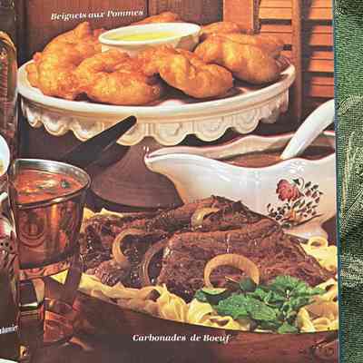 Color inset: Right page of two-page color photograph spread. Captioned dishes: beignets aux pommes, carbonades de boef, côtes de pore