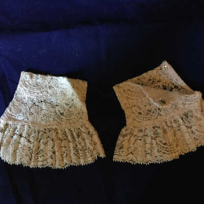 Pair of Ivory lace ruffled wristlets with snap closures