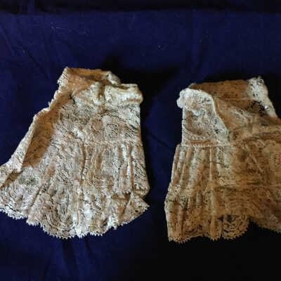 Pair of Ivory lace wristlets with two-tier ruffles and snap closures