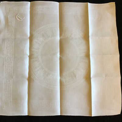 Brushed cotton jacquard dinner napkin, Greek border design and central circle, “C” monogram.