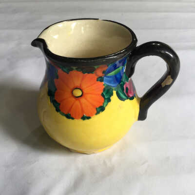 Small yellow pitcher/black handle