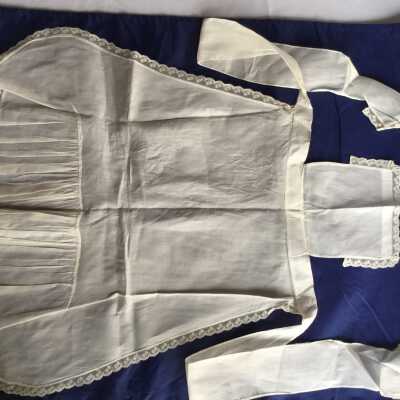 White cotton child’s pinafore