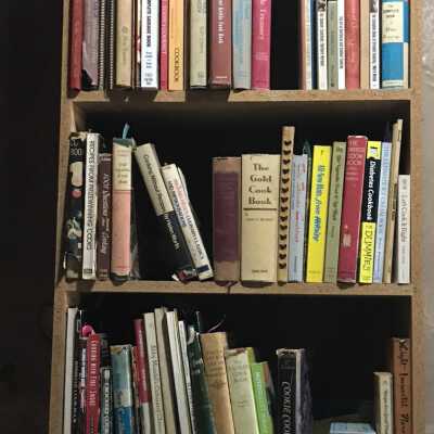 Cook books to right of Dining room door