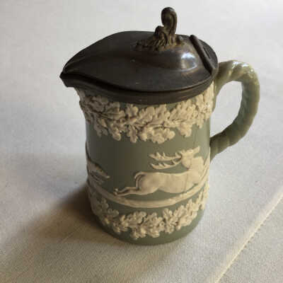 Small green pitcher with metal top