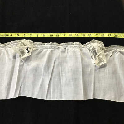White cotton W.A.Bray baby undershirt with lace sleeves and trim.