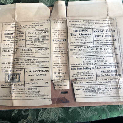 Inside of paper book cover. Adds for local shops. 