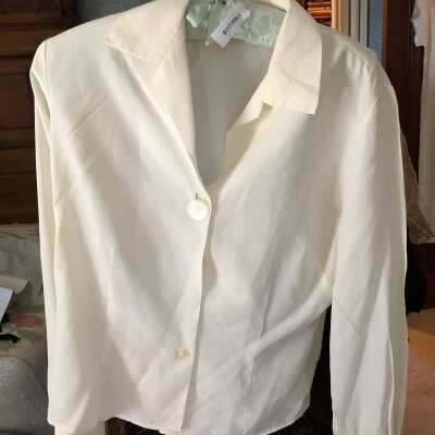 Blouse white. 1decorative button at center of neck 