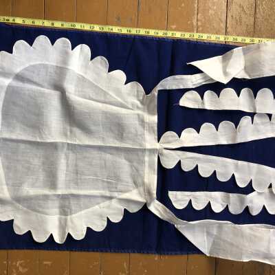 White voile scalloped-edge maid’s apron with scalloped shoulder straps and straight waist ties