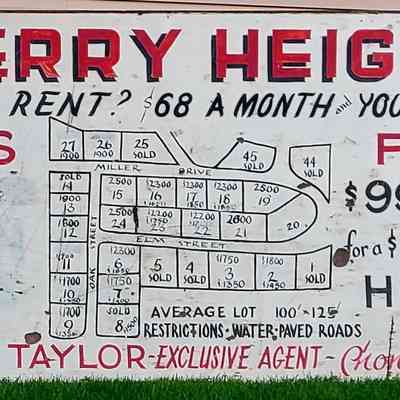 Cherry Heights Development advertising sign closeup: The image shows a Cherry Heights advertisement for lots with financing options starting at $68 per month.