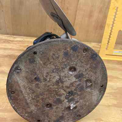 General Electric oscillating electric fan - bottom view.: The image shows the bottom of the three-blade metal fan that was used in the 1915 Erie Station.