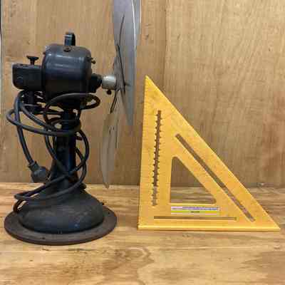 General Electric oscillating electric fan - left side view.: The image shows the left side of the three-blade metal fan that was used in the 1915 Erie Station.