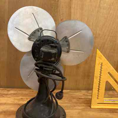 General Electric oscillating electric fan - back view.: The image shows the back side of the three-blade metal fan that was used in the 1915 Erie Station.