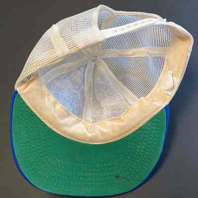 Stephen Schlinger's Troy Little League Team cap - underside: The image shows a cap with a green brim and a white mesh interior, laid flat.