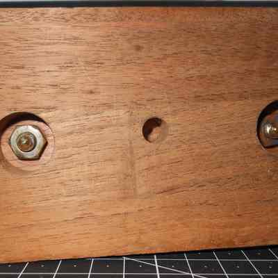 Charter Member Leander Keeney Trophy bottom view: The wooden base with three holes and two embedded metal nuts is shown.