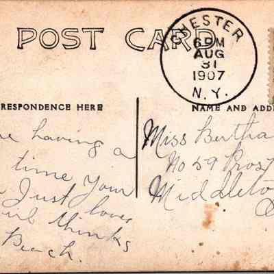 “City Pharmacy Chester NY” Back: The image shows a vintage postcard from 1907 with an adorned left side and handwritten content on the right. It features a postmark from Lester, New York, dated August 31, 1907, and a green one-cent stamp depicting Benjamin Franklin. Addressed to Miss Bertha Barker in Middletown, New York, the message on the card says “We are having a fine time. Your Mama just loves my girl thinks she’s a peach.  [?]”. The handwriting is in cursive, flowing across the designated correspondence section of the postcard.