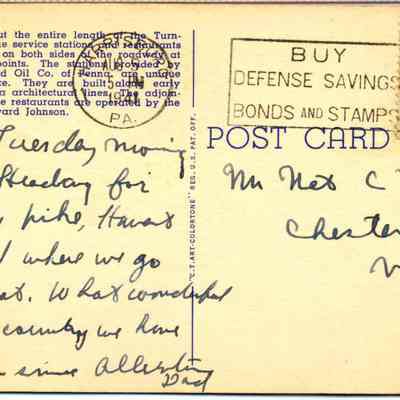 Address side of the "Pennsylvania Turnpike" postcard.: The image depicts an old postcard with both printed and handwritten text, including a message written in cursive ink mentioning "Tuesday morning 10.30" and referring to travel on a new pike, alongside an address to "Mr. Nat C. Roe" in Chester, NY. The postcard features a 1-cent United States postage stamp and a stamp advocating for the purchase of defense savings bonds and stamps. Additionally, the printed text describes the features of Pennsylvania Turnpike service stations and restaurants built along early Pennsylvania architectural lines.