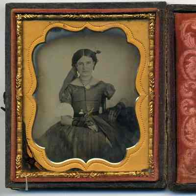 Seated lady with tinted cheeks and gold watch