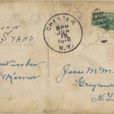 Address side of the "McMunn Road Stand" postcard.: The image depicts an old postcard dated June 15, 1915, as indicated by the postal stamp from Chester, N.Y., at 8 PM. It features a green "Panama-Pacific Exposition: Balboa" one-cent stamp, in the top right corner. The addition of handwritten "with best wishes, C.W. Kerner," addressed to "Jesse M. Munn" and a reference to "McMun, Road Stand,” signaling personal correspondence.