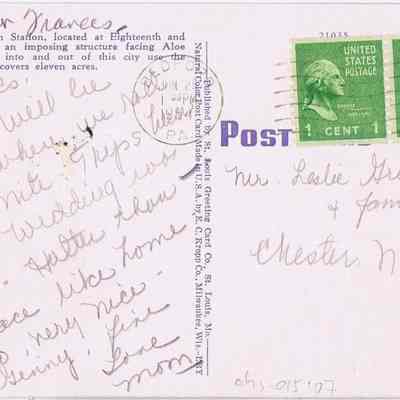 Address side of the "St. Louis Union Station at Night, St. Louis" postcard.: This image shows a vintage postcard addressed to "Mr. Leslie Greenwood & family" of Chitten, N.Y. The front portion of the card, visible on the left side, features handwritten cursive messages. Two green 1 cent George Washington stamps are affixed at the top right, and a postmark from Marked Tree, Arkansas, dated 1954, overlaps slightly onto one stamp. The writing mentions a description of St. Louis' Union Station, personal messages about trips and other thoughts.