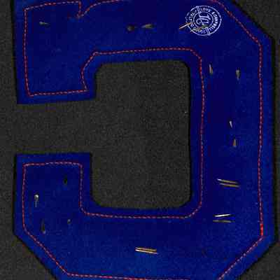 LuAnn Cavallero Varsity Basketball & Soccer Letter reverse: The image depicts a large, blue, felt varsity letter 'C' with orange stitching.