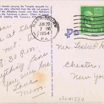 Address side of the " Pennsylvania Turnpike Tunnels" postcard.: The image shows an old postcard dating from June 20, 1954, with a hand-written note and two George Washington one-cent postage stamps. The postmark is from Harrisburg, PA, and the card is addressed to Mr. Leslie E. Greenwood Sr. in Chester, New York. The note, written in cursive, expresses a sentiment from "Mom" and mentions the time 8:30 P.M.