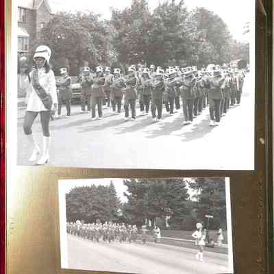 06 Band marching on street with brick building in background. - Band marching on Duham St. (print flipped horizontally).