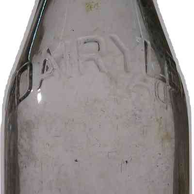 Dairylea Milk Bottle: A vintage glass milk bottle labeled "DAIRYLEA" sits empty, showing signs of aging.