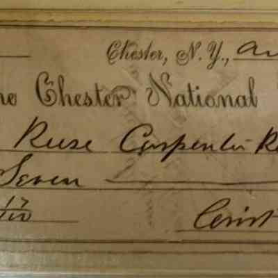 Carpenter Side A: The image shows an old bank check dated August 13, 1880, from The Chester National Bank, located in Chester, N.Y. The check is issued to "Russ Carpenter-Receiver" for the amount of $7.17. The amount is written in both words and numbers, with "Seven" and "17/100 Dollars" respectively, followed by an underlined line indicating the completion of the amount. The signature at the bottom reads "Crist & Son," adding authenticity to the document. The check is bordered with an ornate design on the left, and the typography is a mix of elegant, cursive, and bold styles, characteristic of the 19th century, giving the entire piece a historical and vintage appearance.