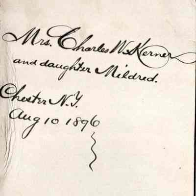 Ms. Charles W. Kerner and daughter Mildred reverse: The image displays an aged, handwritten note identifying the subject on the obverse of this cabinet card photograph as Mrs. Charles W.. Kerner and daughter Mildred, located in Chester, N.Y., dated August 10, 1896, featuring elegant cursive script on a worn, off-white paper with scalloped edges and a pinhole at the top.