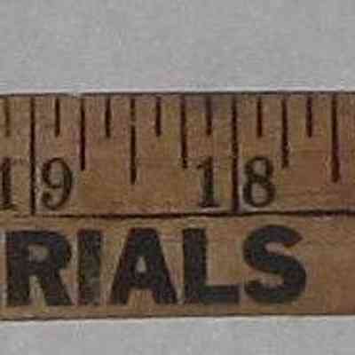 Conklin Lumber Yard Stick used by Bernie Hom in construction - Side B: The image shows a vintage wooden ruler featuring inches and promotional text for a building materials company.