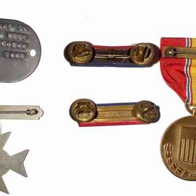 John J. McGrath's Korean War Service Medals - versa: The image depicts back of various military medals and badges with ribbons and engraved details.