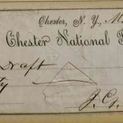 Draft Side A: The image depicts an old-fashioned check from "The Chester National Bank," dated May 11, 1896, in Chester, New York. It is addressed to the Draft and written for the amount of sixty dollars and 20 cents with the numeric expression "$60 20/100" indicating eighty cents. The check features ornate text with flourishes, especially in the bank's name, and includes decorative border patterns on the left side. It is signed by someone with the initials J.[?]. Clark. The paper shows signs of aging, including discoloration and creases, reflecting its historical nature. The overall design is formal and indicative of financial documents from the late 19th century. The script style is elegant and indicative of the period's handwriting conventions, providing a glimpse into the financial transactions and communication style of the era. This document represents not only a monetary transaction but also a piece of history, capturing the essence of American banking practices in the post-Civil War period.