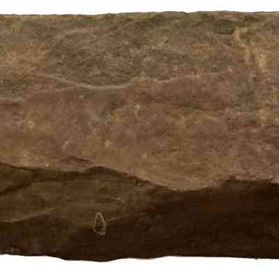 1762 "Roe Homestead" Cornerstone - bottom: The image shows a rough, textured, shale stone with an uneven, jagged surface and an irregular