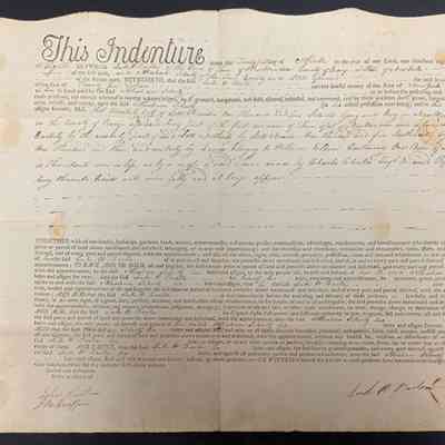 Luke Barton to Abraham Schultz 1808 Land Deed - Front: The image displays an old legal document titled "This Indenture," characterized by its formal layout and ornate script. The document consists of pre-printed text filled in with handwritten entries, detailing a legal agreement made on the twenty-first day of April, in the year 1808. It outlines a transaction between parties, involving the conveyance of land in Orange County, New York, specifying conditions and legal descriptions. The text includes legal jargon common in contracts of the era, such as terms specifying the rights, privileges, and appurtenances related to the property transferred. Signatures are present at the bottom, as well as handwritten acknowledgments, suggesting the document is signed and sealed by the involved parties in the presence of witnesses. The edges of the document are slightly stained and worn, indicating its age and historical nature.  Land deed from April 21, 1808 between Luke W. Barton and Abraham Schulz (Schultz) for the sum of 25 dollars for a lot in New Windsor NY