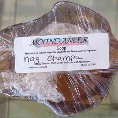Nag Champa Moondancer Soap - bottom: The image shows a bar of Moondancer soap wrapped in plastic labeled "Nag Champa."