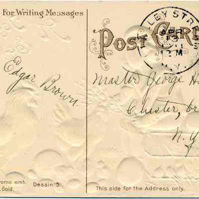 Address side of the "A Joyful Easter" greeting postcard.: This image depicts the back of an embossed vintage postcard with a decorative border, addressed to Master George Hawkins in Chester, Orange County, N.Y., and postmarked in 1911. The postcard is stamped with a green one-cent United States postage stamp and features an embossed design of a rooster, eggs, and foliage. It is printed in Germany, with a unique design labeled as "No. 15770. Chromo emb. Dessin 5" and "No. 15802.