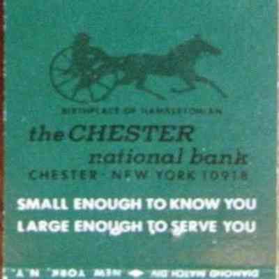 Chester National Bank Matchbook cover: The image depicts a matchbook cover from Chester National Bank, featuring text that reads: "The little bank... with the big heart," highlighting its dual philosophy of being "small enough to know you, large enough to serve you." It also states the bank's location as "Chester, New York 10918" and includes the phrase "Birthplace of harness racing." The design includes an illustration of a horse and sulky, symbolizing the bank's connection to local culture and community.