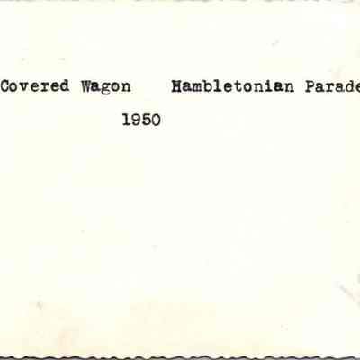 Covered Wagon Hambletonian Parade 1950: The image displays the back of the picture with a typed note "Covered Wagon Hambletonian Parade 1950.  They probably meant to write 1949.