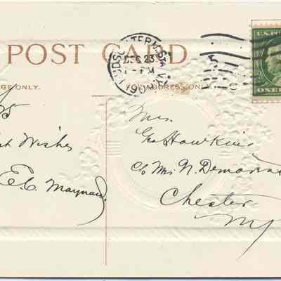 Address side of the "Wishing You a Happy New Year" greeting postcard.: The image displays an old postcard with a white embossed featuring floral designs and a centralized section marked "POST CARD." It is addressed to "Mrs. Geo. Hawkins" with handwritten text on it, including a postmark date from Hudson Term. Sta., NY and a one-cent green U.S. postage stamp depicting Benjamin Franklin. The card includes several personalized, handwritten messages, reflecting a form of communication from an earlier era.
