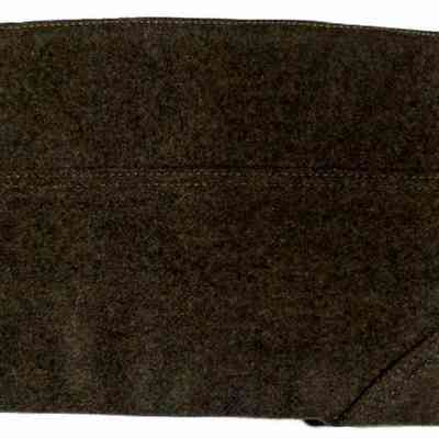 John J. McGrath's Marine Service Cap - other side.: The image depicts a dark green, military-style wool garrison cap, laid flat, with visible stitching