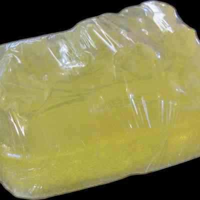 Jasmine Moondancer Soap: A translucent yellow bar of soap is wrapped in clear plastic packaging for protection.