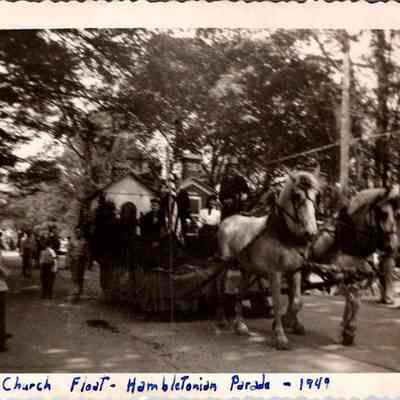 School House - Church Float - Hambletonian Parade - 1949: This vintage black-and-white photo depicts a horse-drawn float with a school house on it.
Bern Mennelaar School Float.