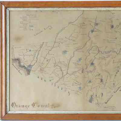 Circa 1850/60 Orange County, NY Map: The image displays an old, framed map of Orange County, featuring hand-drawn details of towns, rivers, and boundaries, with New Jersey marked prominently to the south. It includes a legend in the top left corner, identifying various symbols and references, and the map is encased in a wooden frame that adds an antique touch. The map's intricate detailing shows settlements and regions, and handwriting can be observed across different areas, giving an impression of historical mapping techniques used during that period.