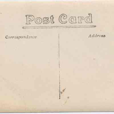 Address side of the "Man posing with cow" postcard.: The image shows a vintage postcard with sections for correspondence and address.