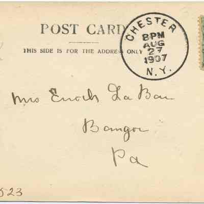 Address side of the "Red Bridge, Chester, N.Y." postcard.: The image shows the back of an old postcard dated August 27, 1907, postmarked in Chester, N.Y. It features a green one-cent stamp and is addressed to Mrs. Enoch La Bar in Bangor, Pennsylvania. The card notes, "THIS SIDE IS FOR THE ADDRESS ONLY," indicating the design conventions of the time, and there's a handwritten note or number in the corner. The phrase "Made in Germany" signifies the card's origin.
