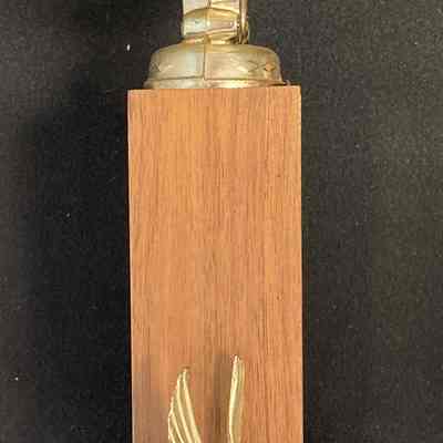 Chart Member Chester Volunteer Ambulance Corp - Henry Lutjens - Left: The image shows the left side of a golden ambulance trophy atop a wooden base, featuring a small eagle detail.
