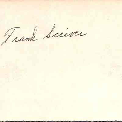 The image shows a name, "Frank Scriver," written in black ink on the back of picture with horse and wagon with flags.